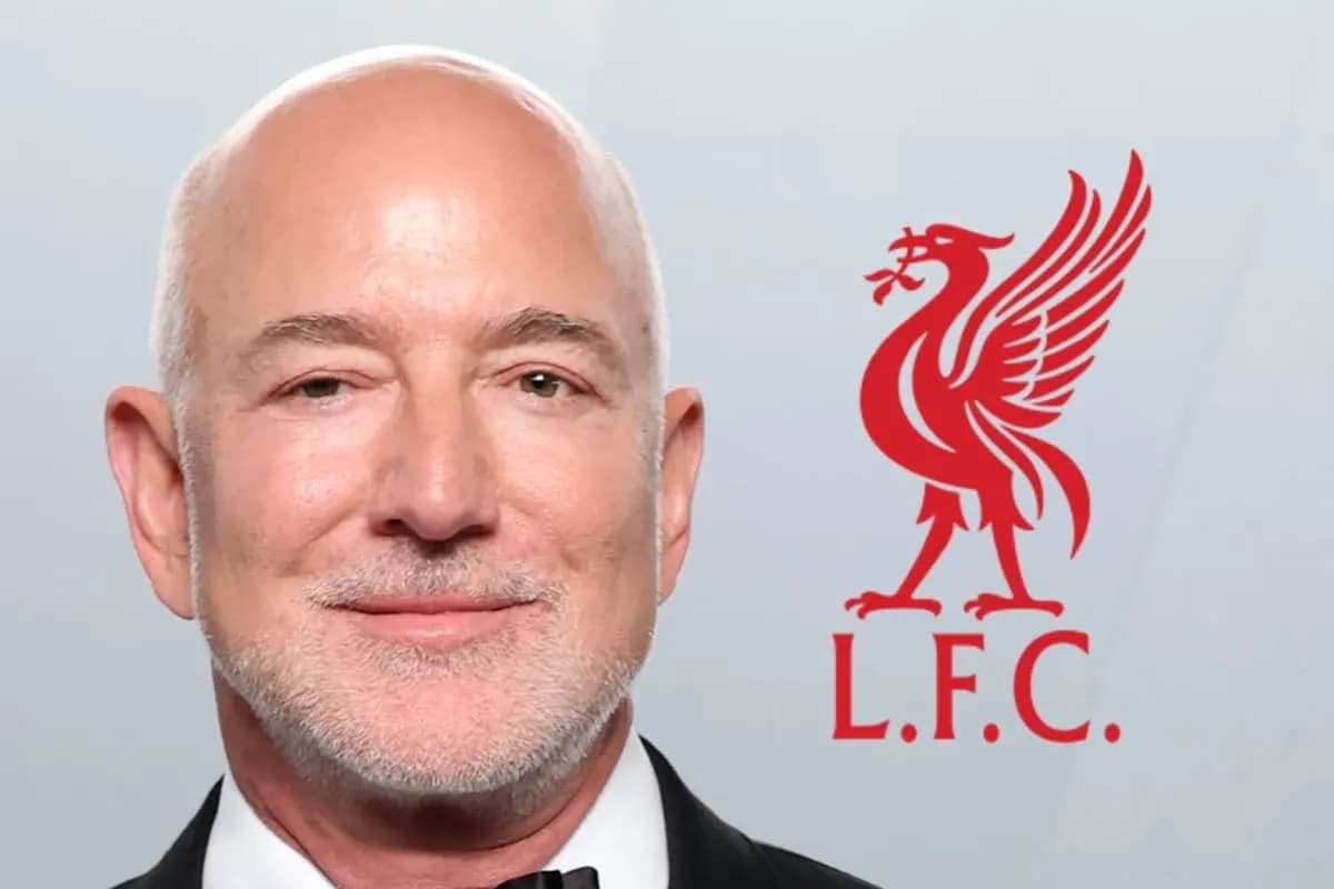 Man in tuxedo with Liverpool FC logo in background