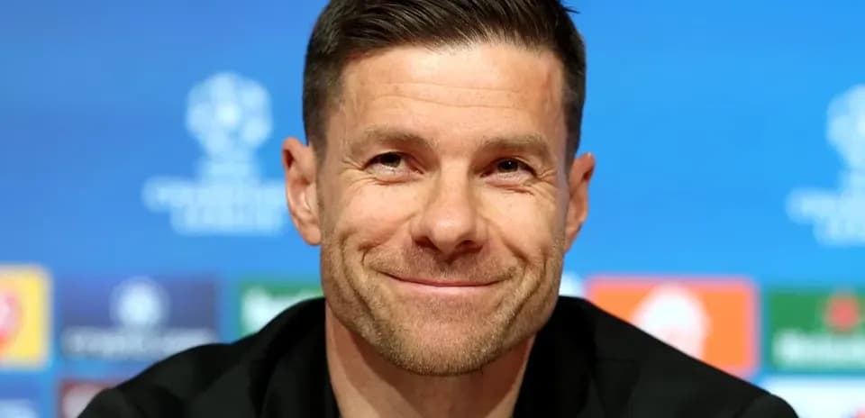 Manager smiling at pre-match press conference