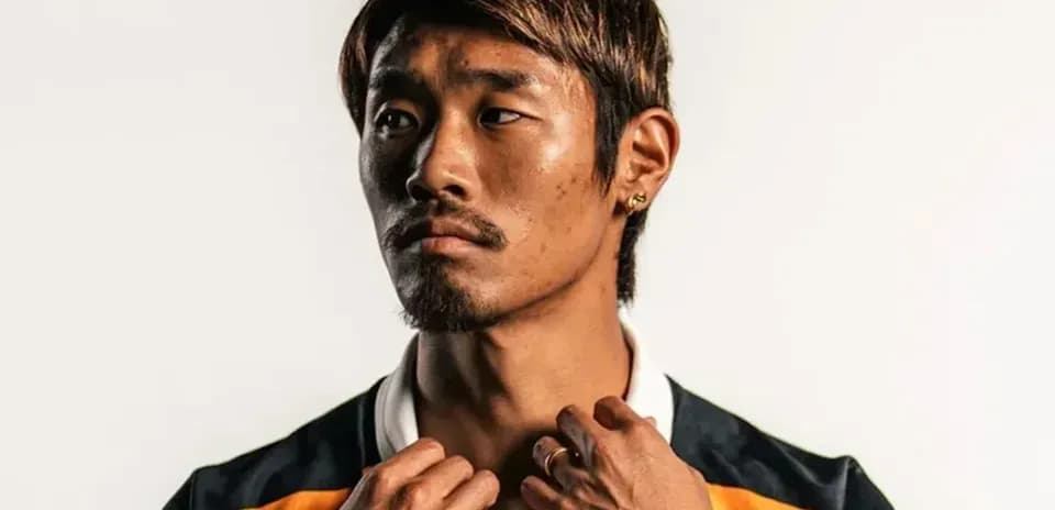 Player posing in team jersey with accessories