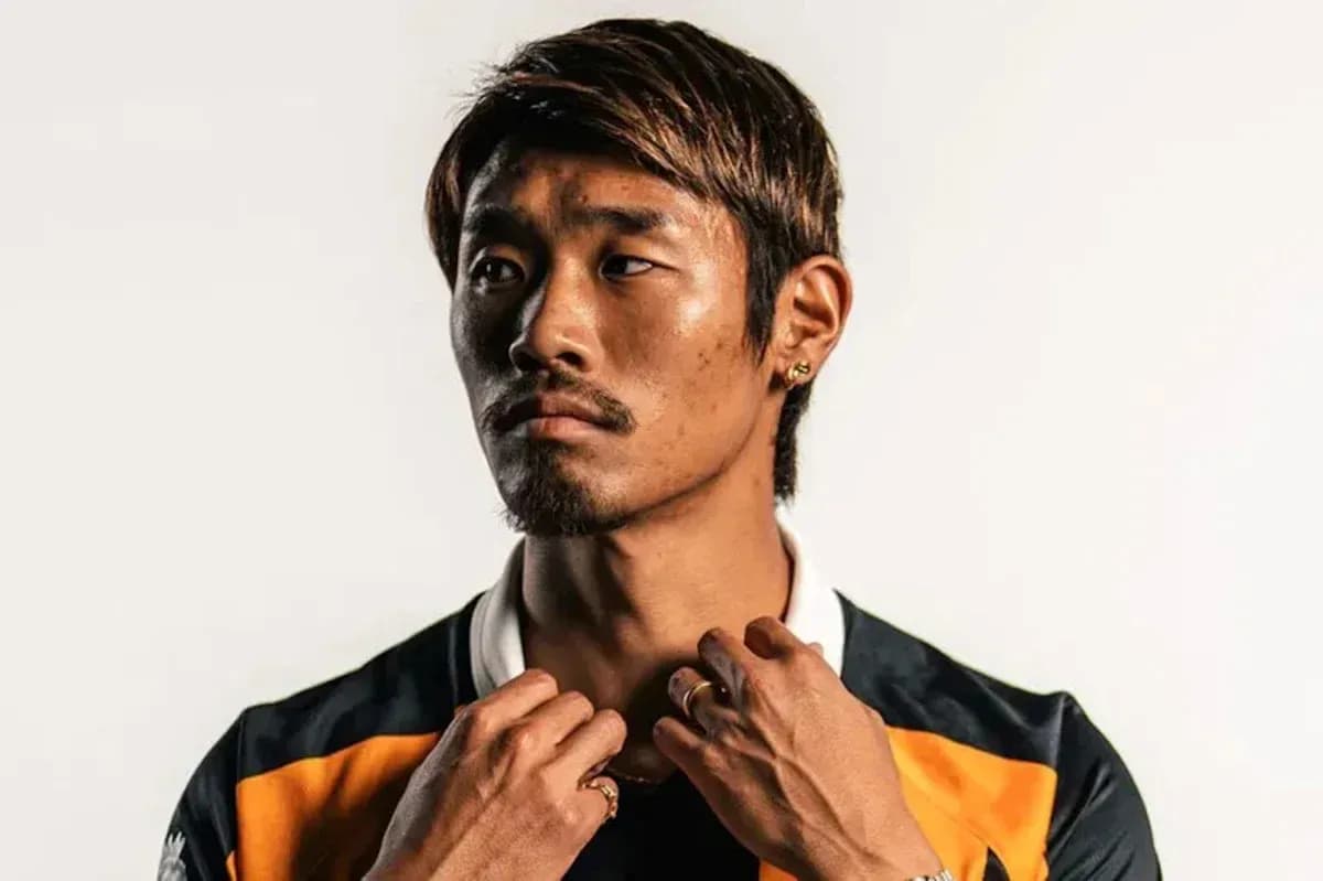 Player posing in team jersey with accessories