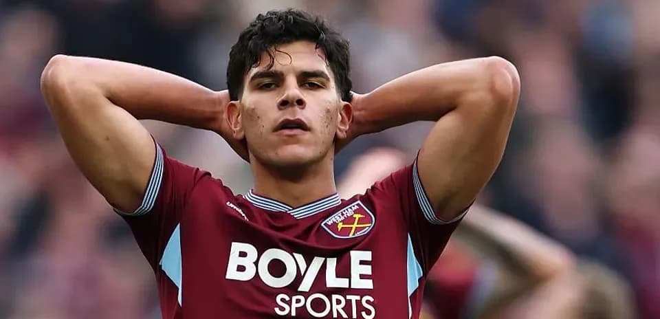Player in West Ham jersey with hands on head