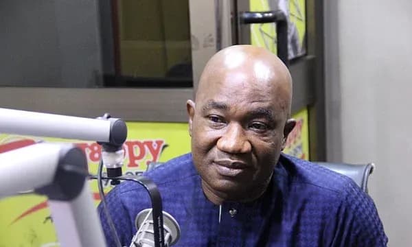 Man speaking into a microphone in radio studio