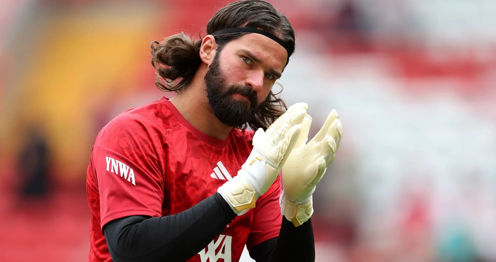 Goalkeeper applauding while wearing gloves before match