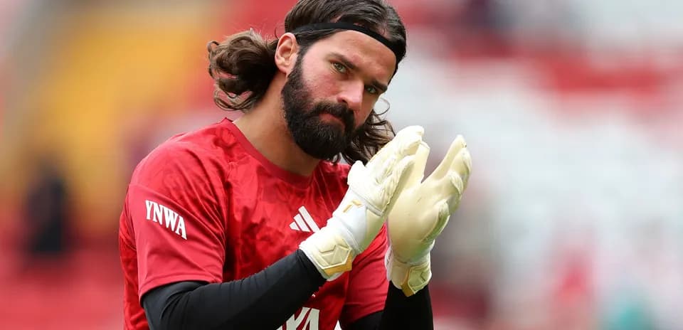 Goalkeeper applauding while wearing gloves before match