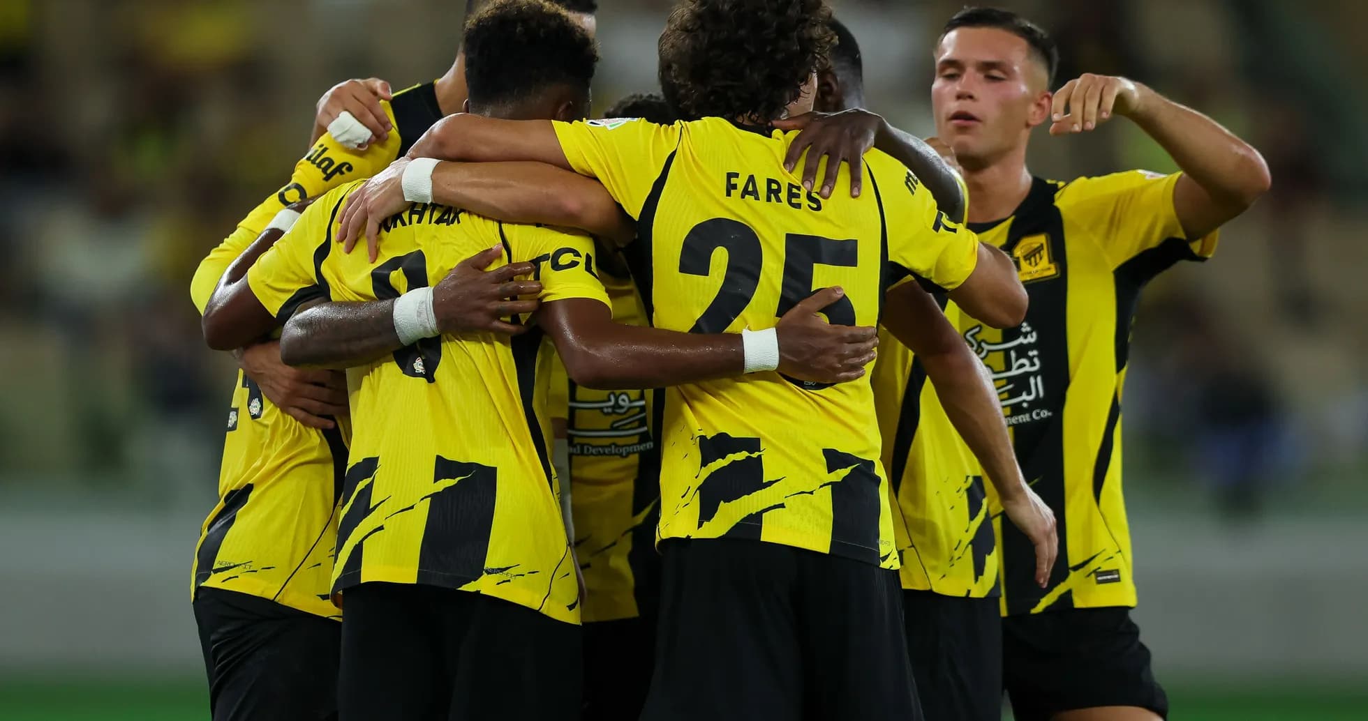 Players celebrating together in yellow jerseys