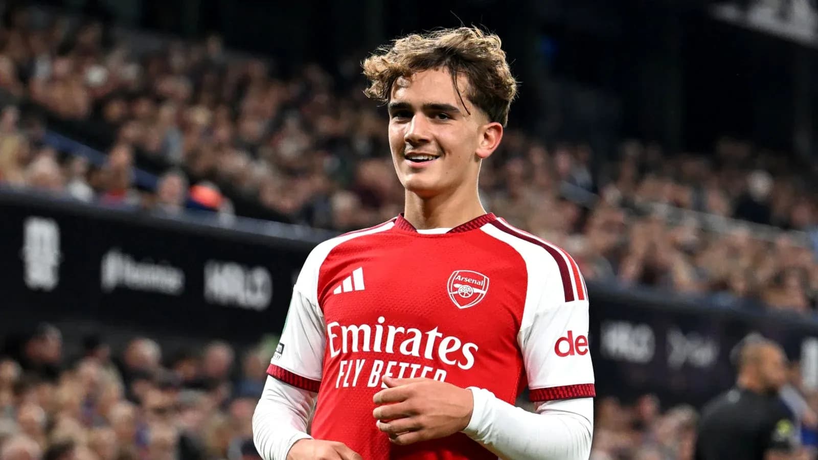 Arsenal player smiling during match at stadium