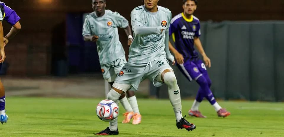 Player passing the ball during MLS Next Pro match