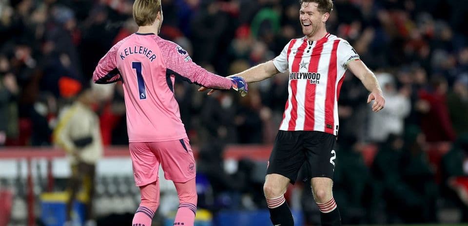 Goalkeeper and defender celebrating after match victory