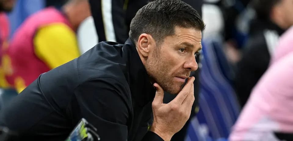 Coach deep in thought during match on sidelines