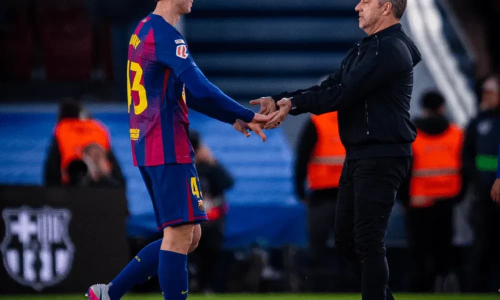 Player shaking hands with coach on the field