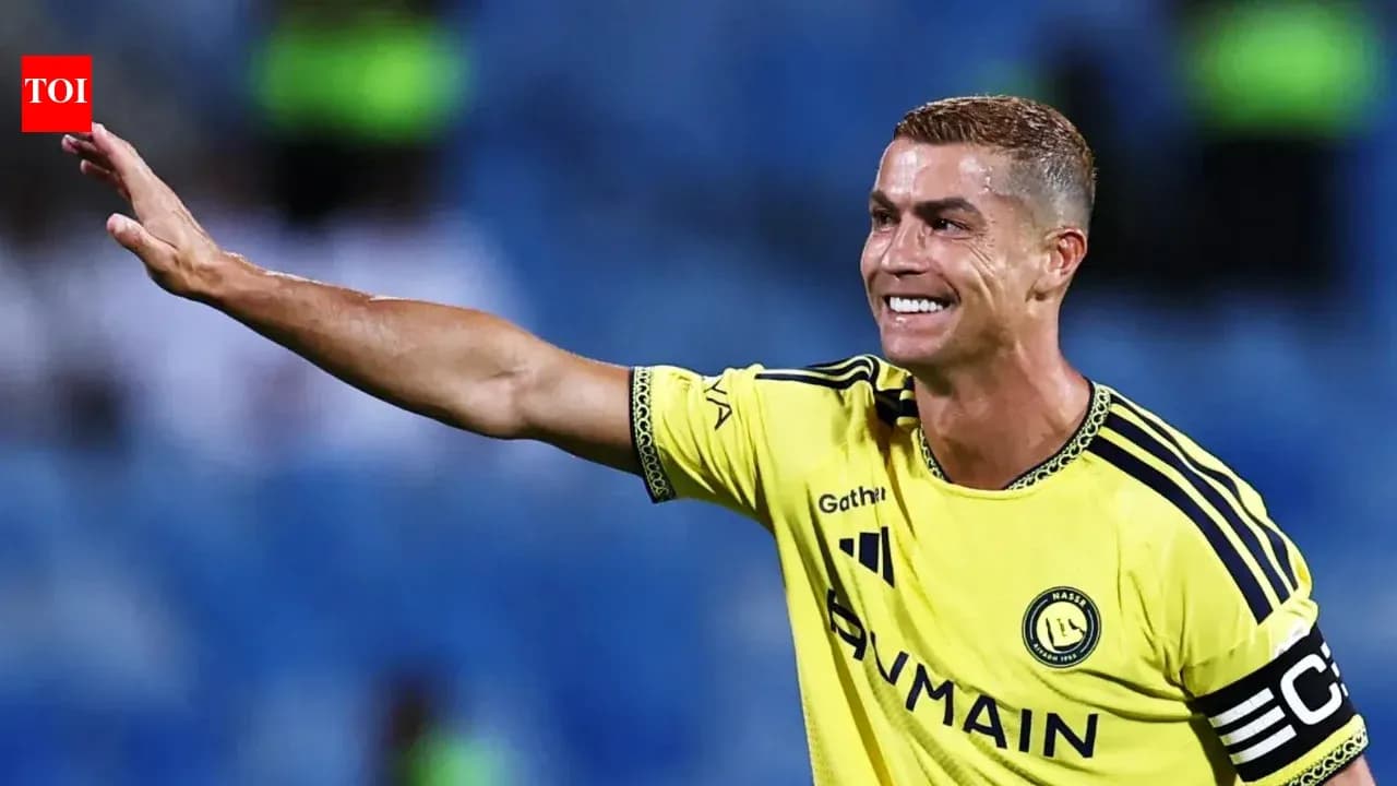 Player in yellow jersey waving to fans