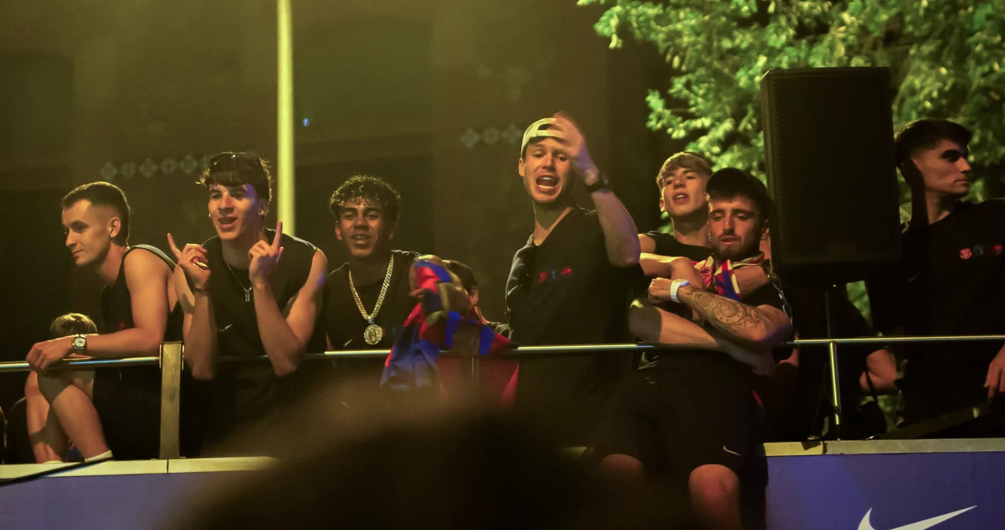 Group of young fans celebrating on balcony