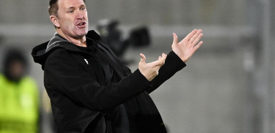 Coach gesturing on the sidelines during a match