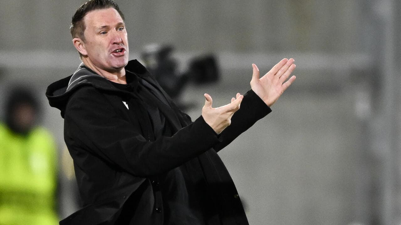 Coach gesturing on the sidelines during a match