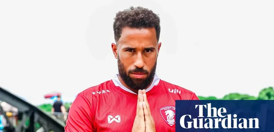 Player in red jersey making a praying gesture