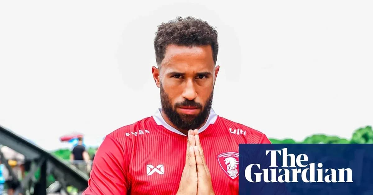Player in red jersey making a praying gesture