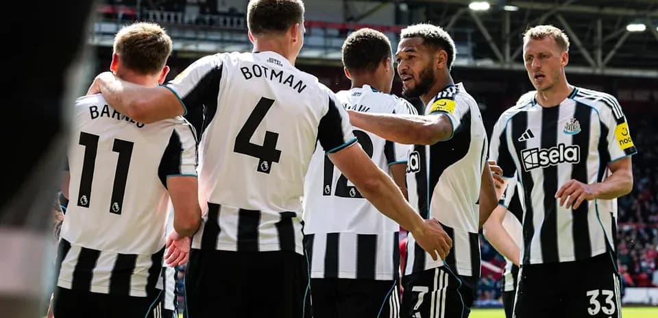 Newcastle players celebrating a goal on the pitch