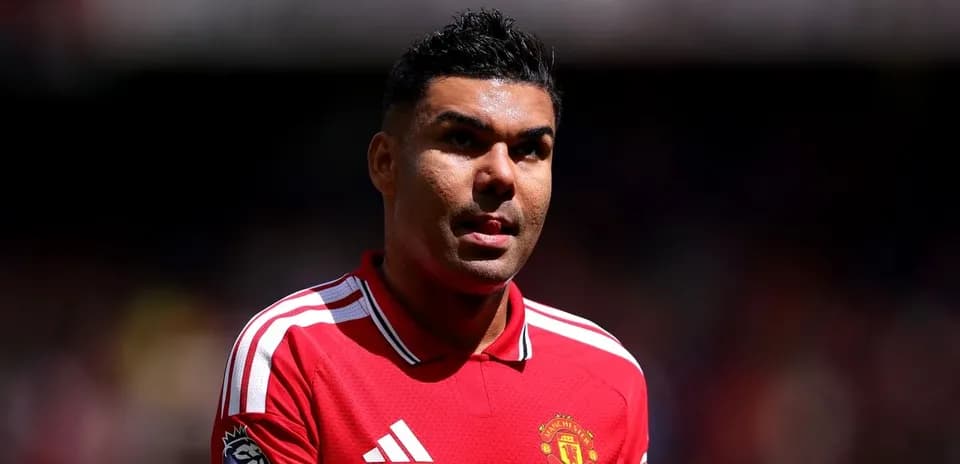 Player in Manchester United jersey on the pitch