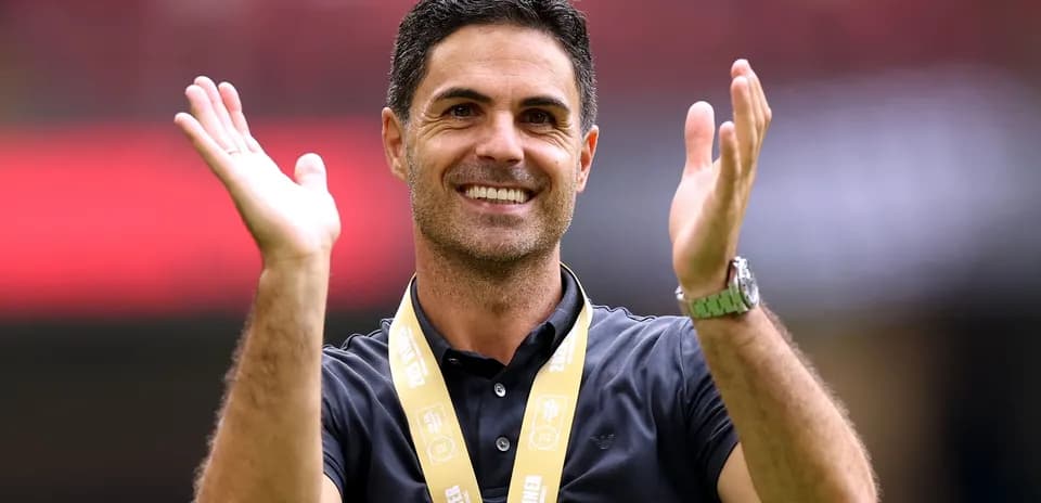 Coach celebrating with a medal at the stadium