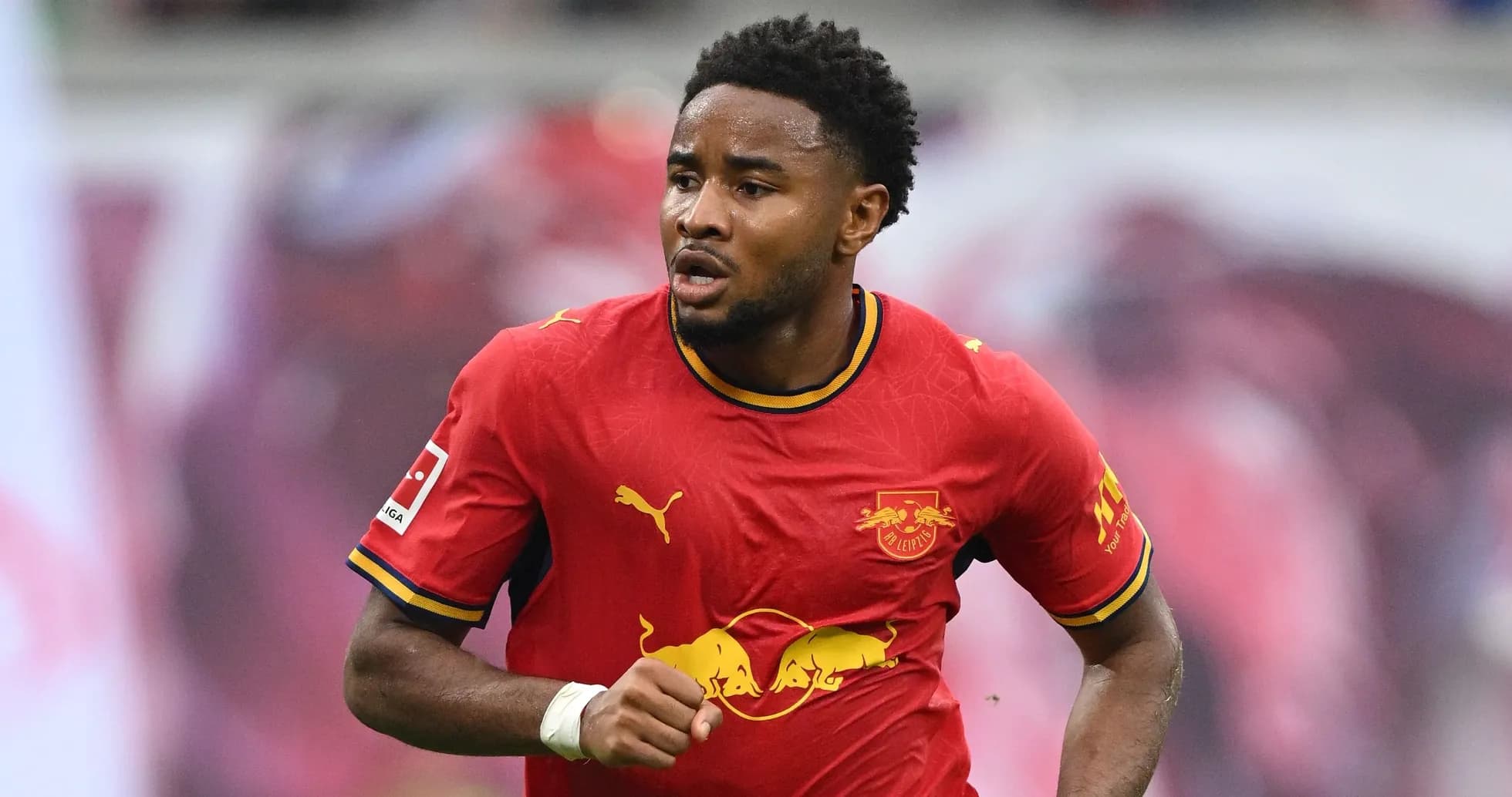 Player running in RB Leipzig red jersey during match