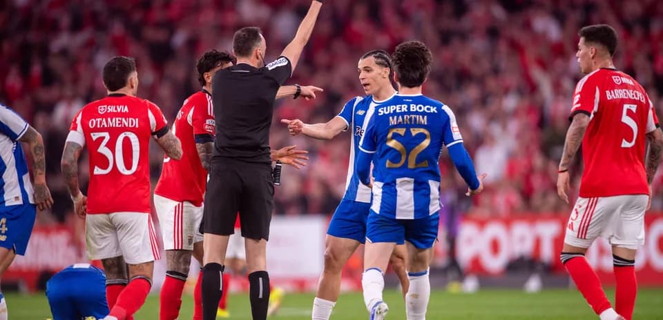 Referee showing yellow card during football match
