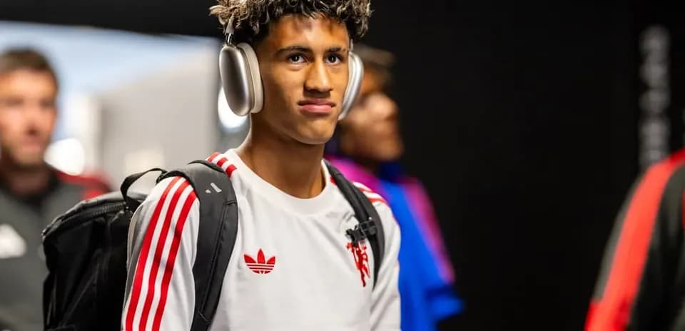 Player entering venue wearing headphones and backpack