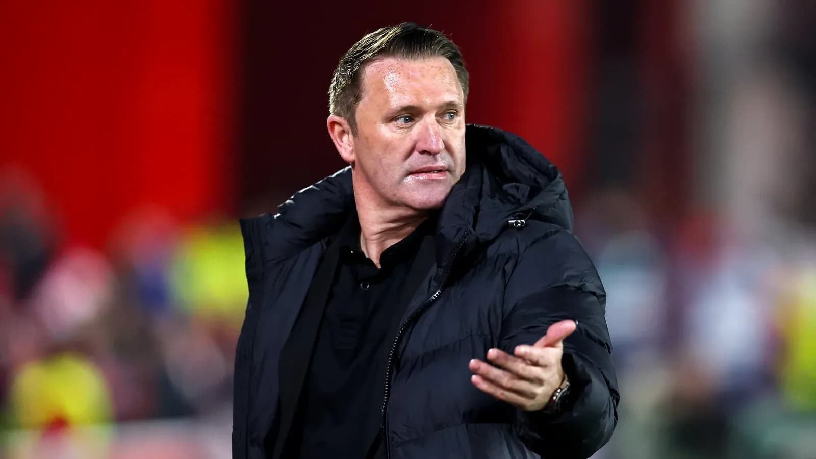 Manager gesturing during a match on the sideline