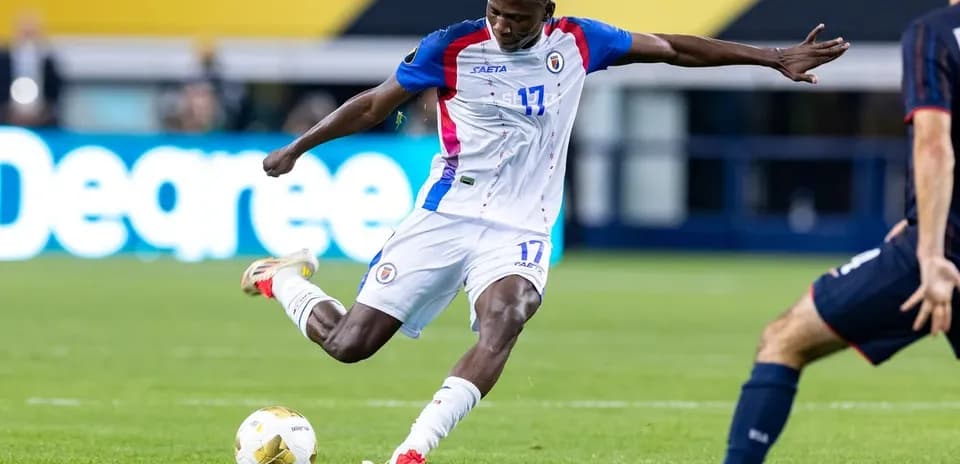 Haitian player kicking the ball during match