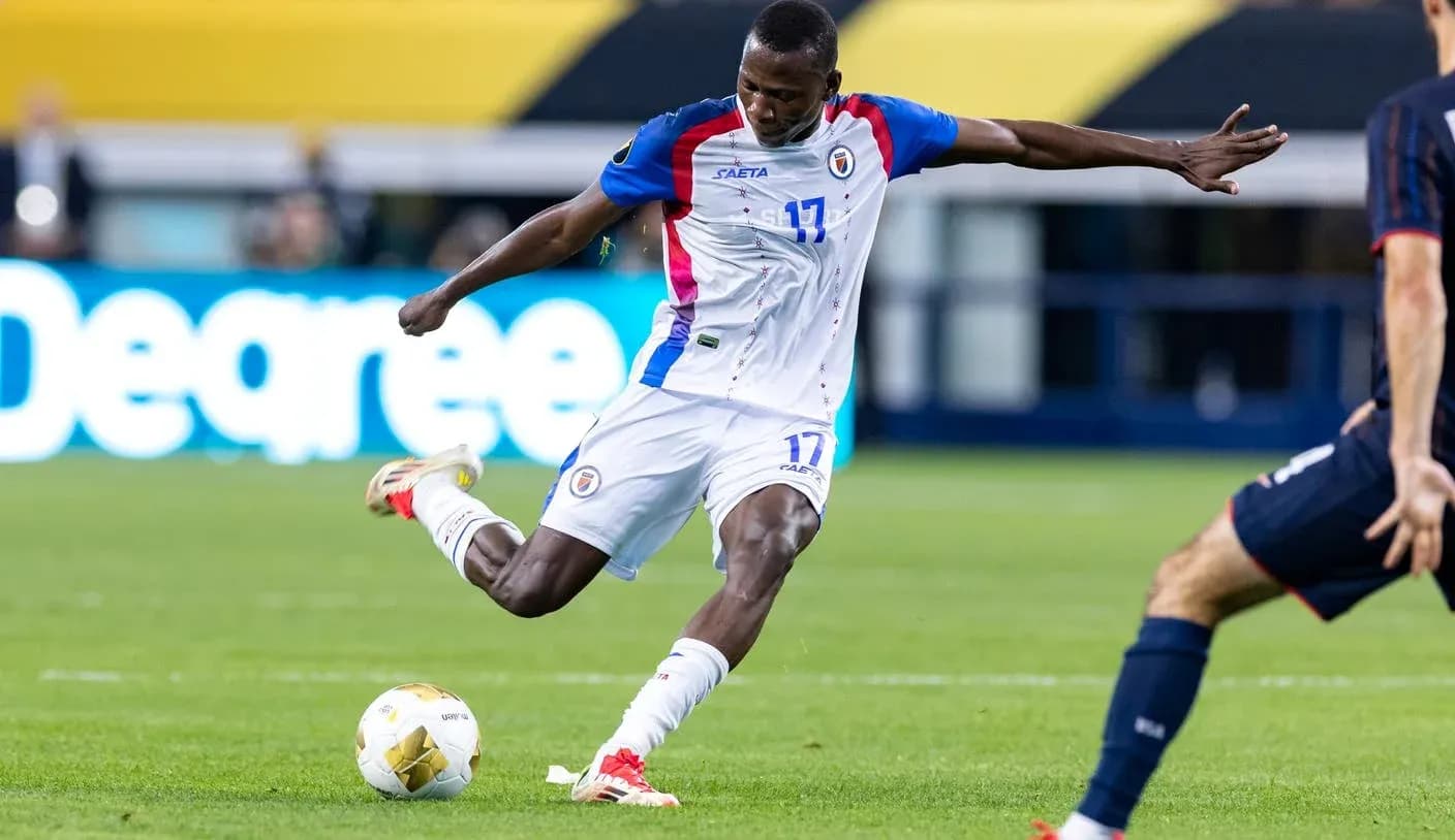 Haitian player kicking the ball during match