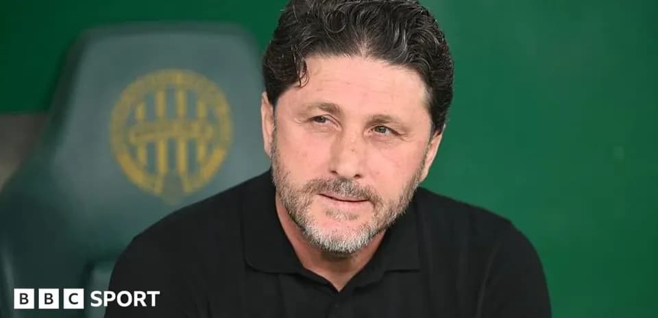 Coach sitting on the bench during a match