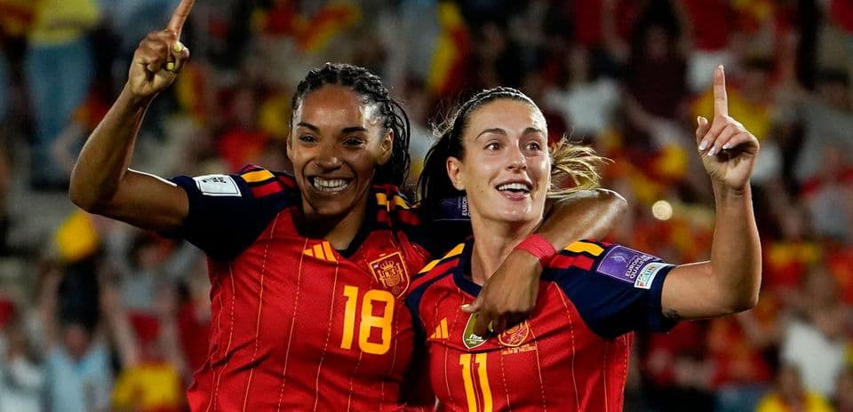Two Spanish players celebrating a goal together