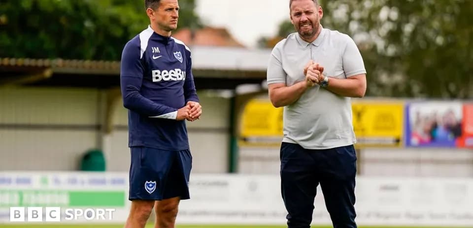 Coach and player discussing on training pitch