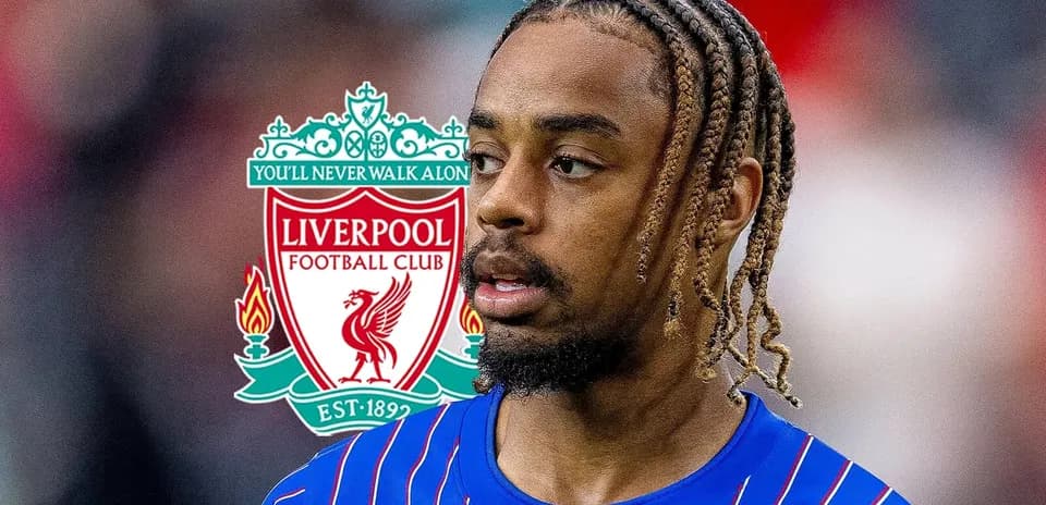 Player in blue jersey with Liverpool logo background