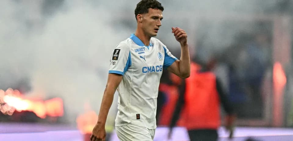 Player walking on field during match with smoke