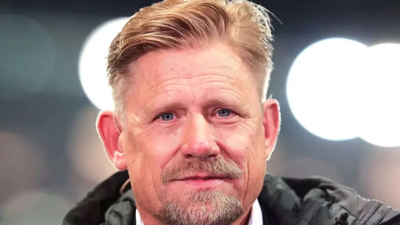Man with blonde hair and beard smiling at camera