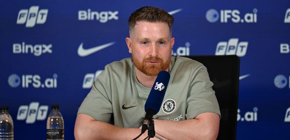 Speaker at press conference with Chelsea branding
