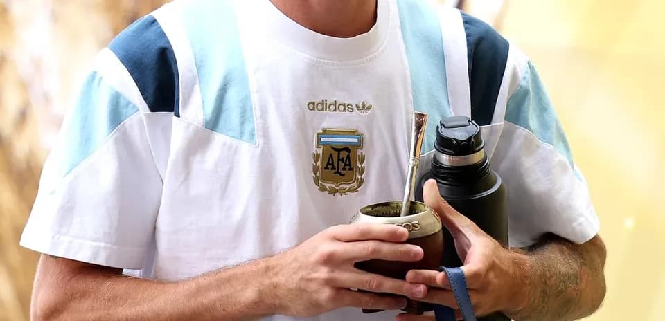 Player holding mate and water bottle in training gear