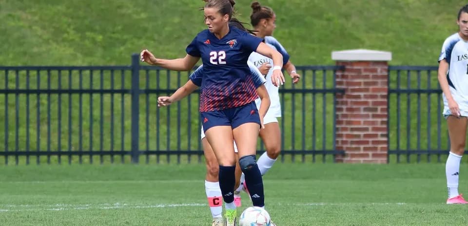Player 22 dribbling the ball during soccer match