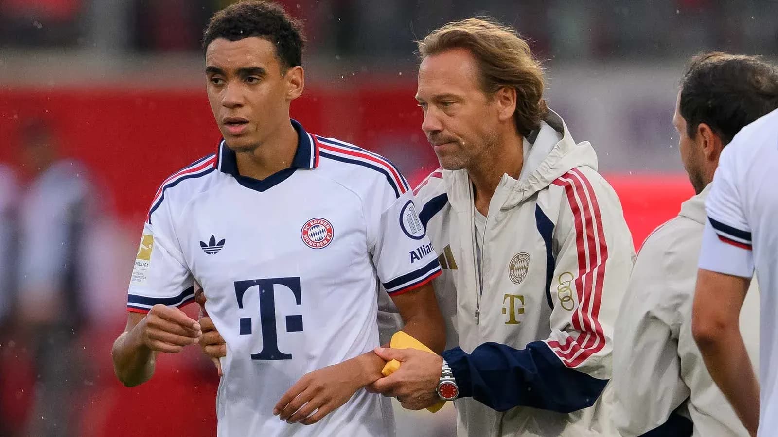 Bayern Munich player receiving guidance from staff