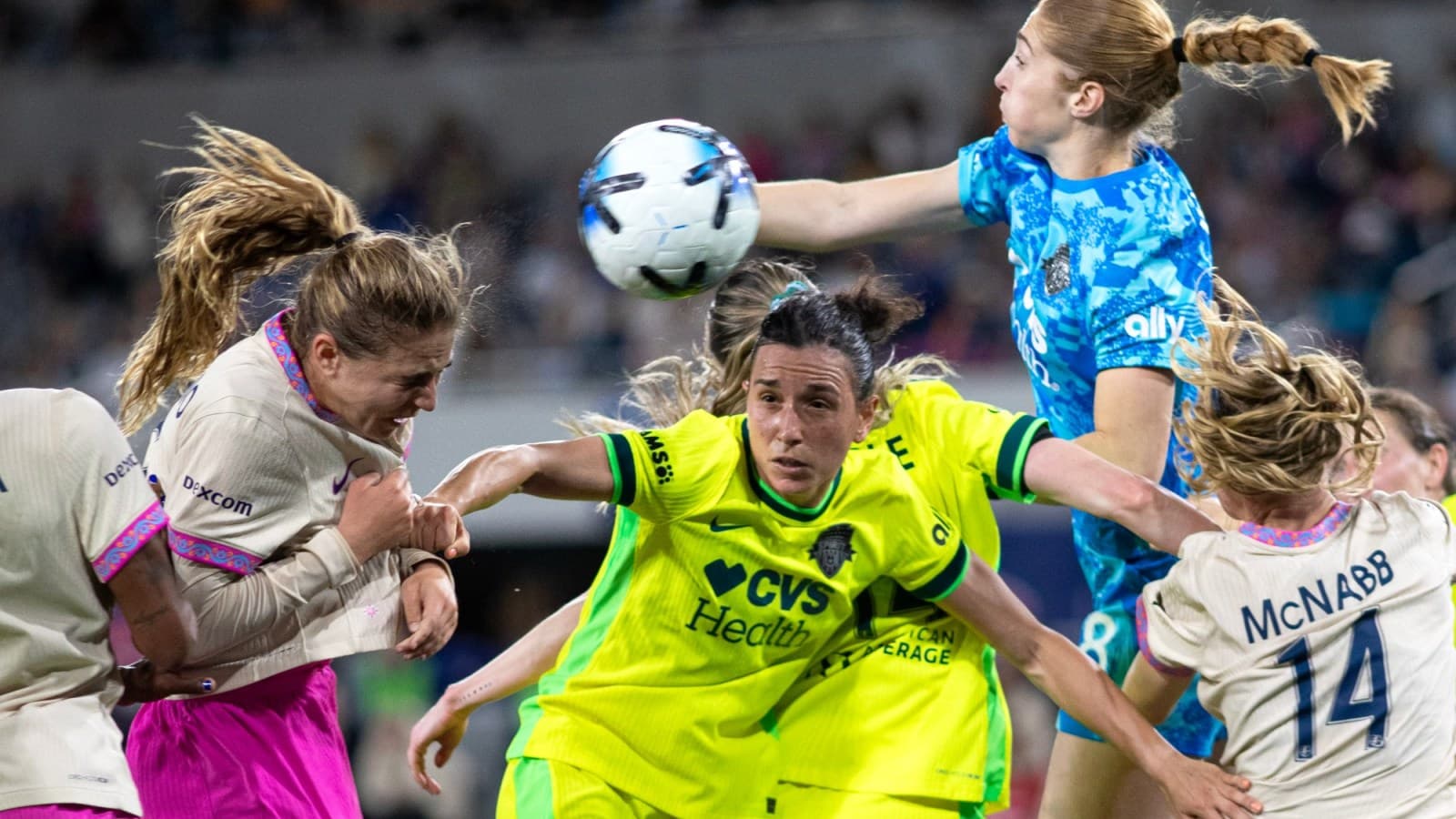 Players competing for the ball during NWSL match