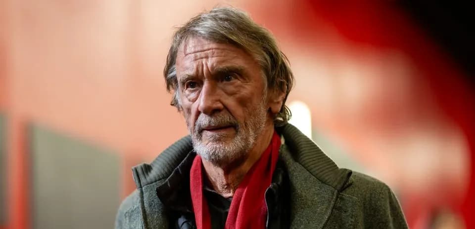 Man with gray hair wearing a scarf indoors