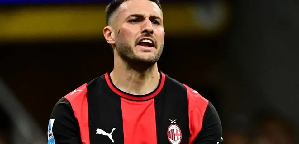Player in AC Milan jersey reacting on the field