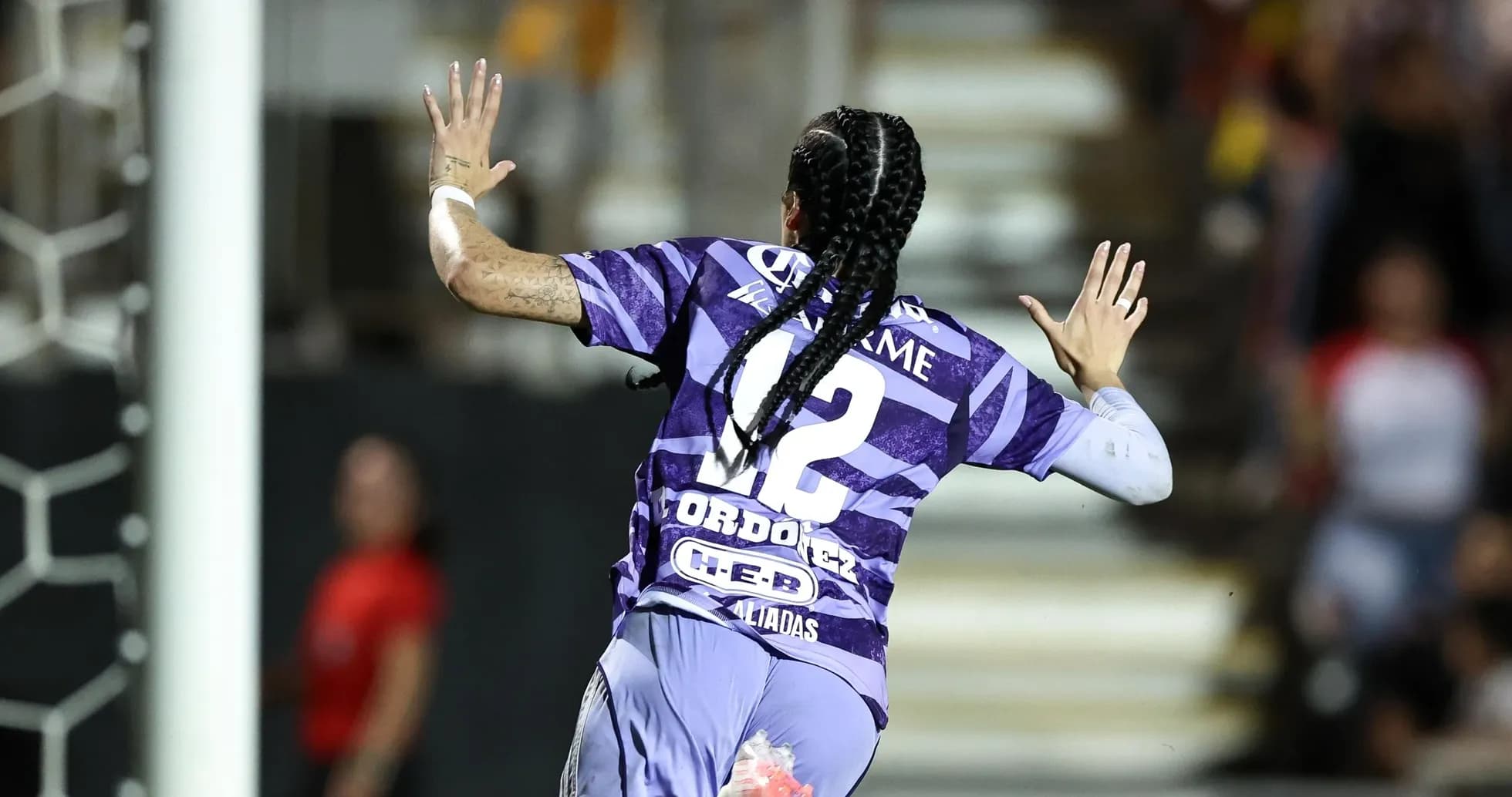 Player celebrating a goal during Liga MX match