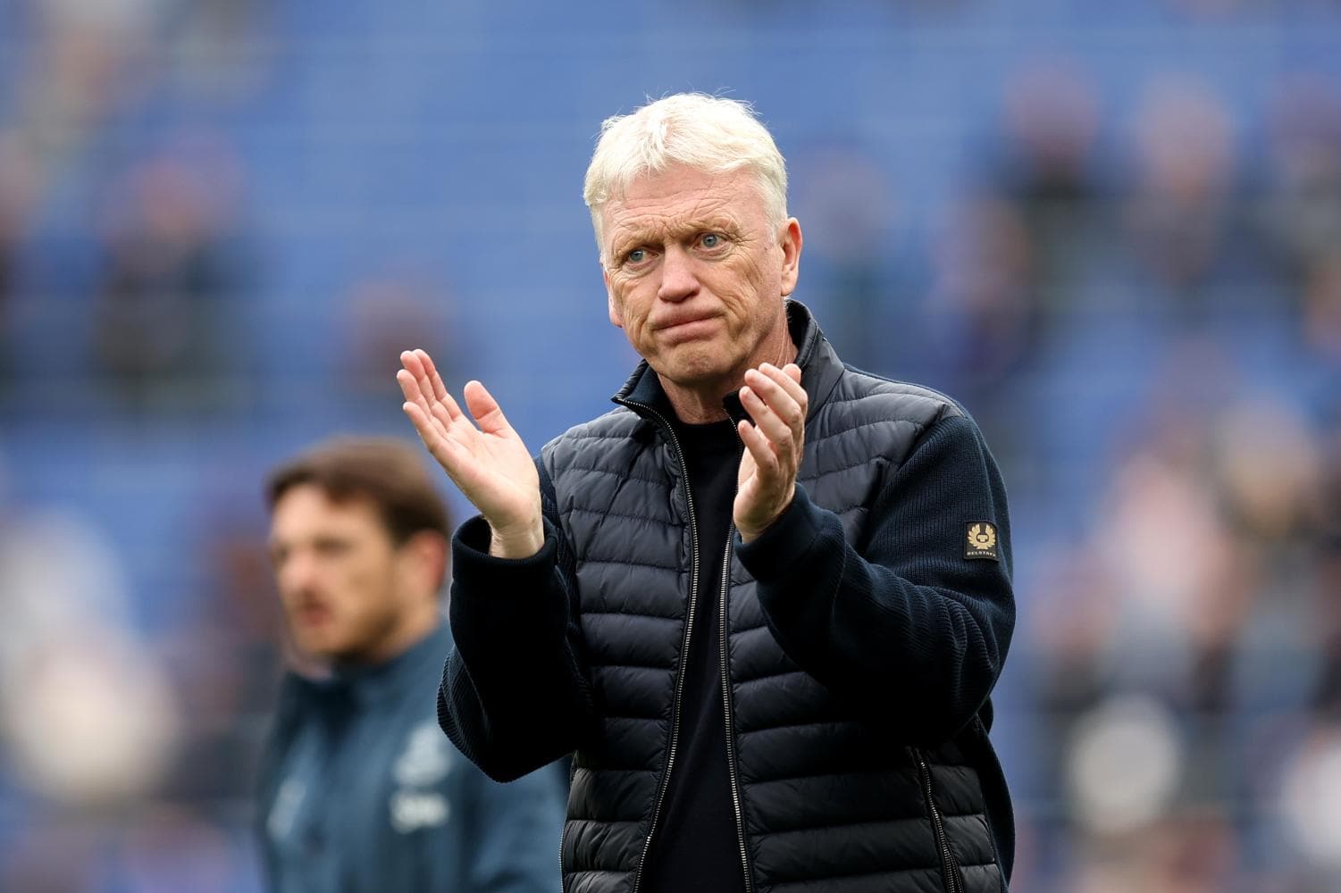 Manager applauding on the sidelines during match