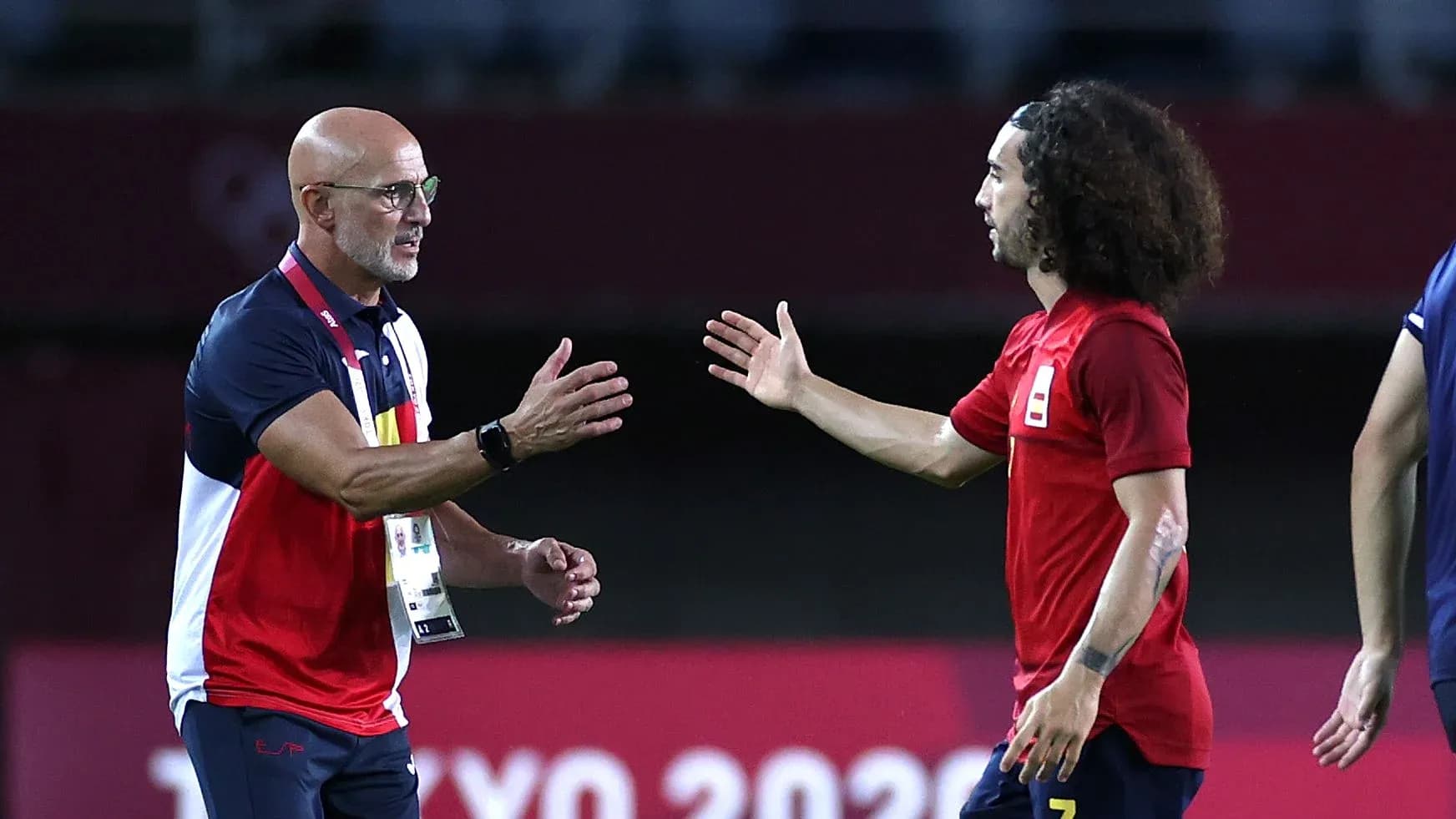 Coach and player shaking hands during match