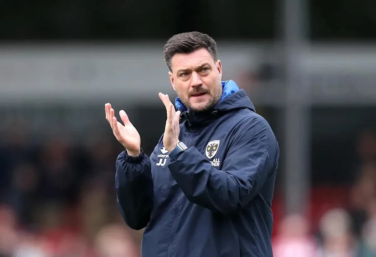 Manager clapping on the sidelines during match