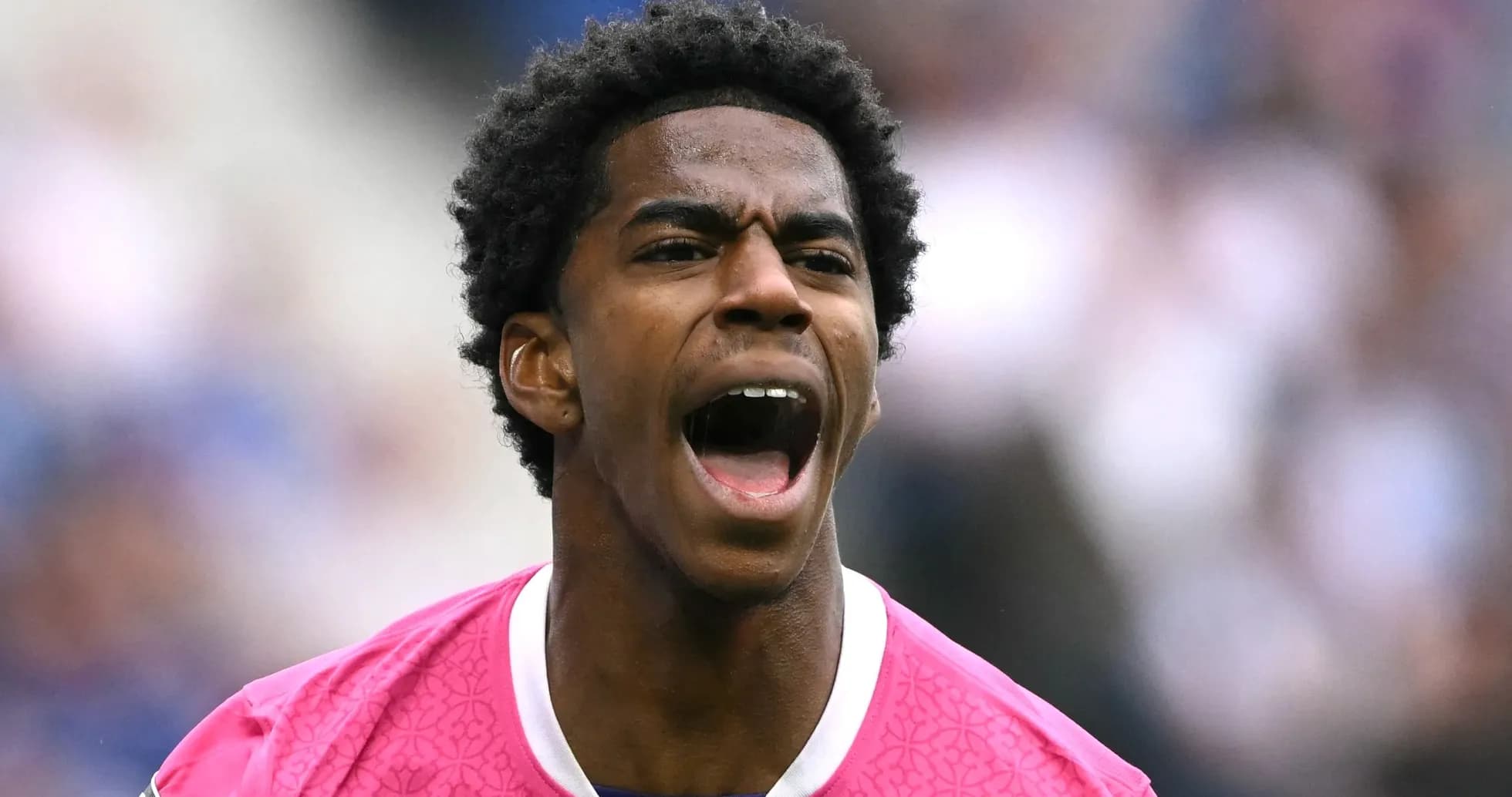 Player in pink jersey shouting during match