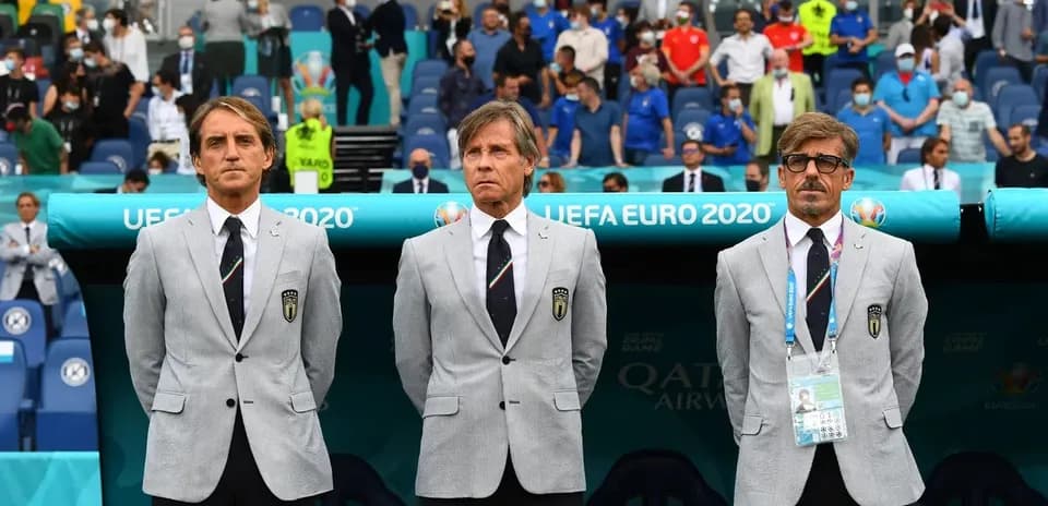 Coaching staff in suits before UEFA Euro 2020 match