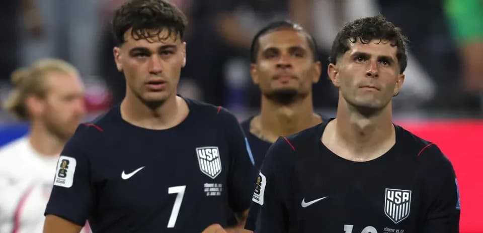 Three USMNT players walking off the field