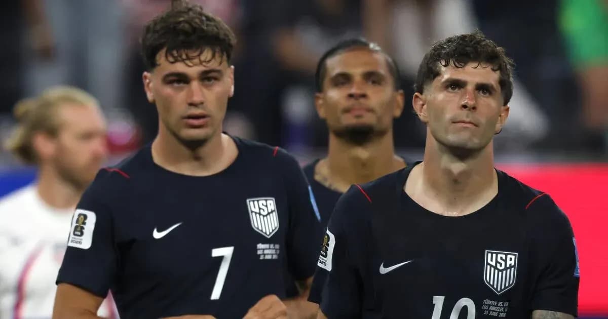 Three USMNT players walking off the field